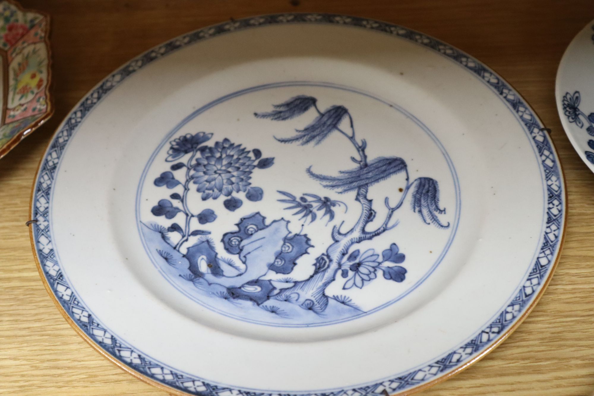 A collection of mostly 18th century Chinese export plates and dishes, a Chinese famille rose dish and another similar smaller dish